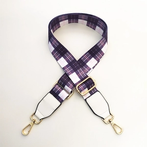 Adjustable plaid canvas bag strap in purple and pink with gold swivel hooks