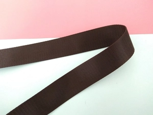 Close-up of durable dark brown nylon shoulder strap showing dense twill weave texture