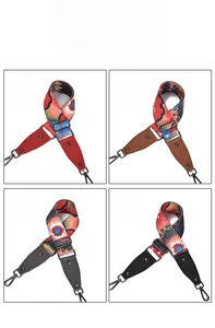 Detail of four ethnic style wide shoulder straps with leather ends and metal swivel hooks