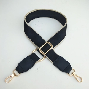 Adjustable black canvas bag strap with beige edges and gold-tone metal hooks