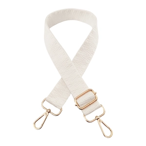 Detail of adjustable cream woven wide bag strap with durable gold metal spring hooks
