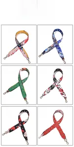 Detail view of six colorful patterned wide shoulder straps with metal lobster clasps