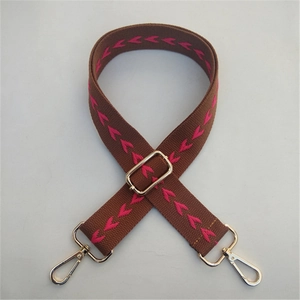 Adjustable brown and pink ethnic canvas bag strap with gold metal hooks for cross-body use