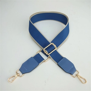 Adjustable wide shoulder strap in navy blue and beige woven design with gold hardware