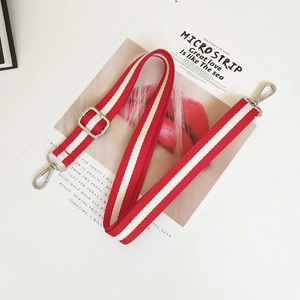 Detail of red and white striped canvas bag strap with silver metal swivel hooks
