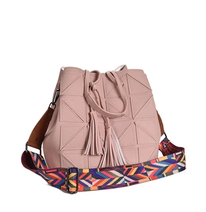 Detail of pink crossbody bag with geometric stitching and colorful woven shoulder strap