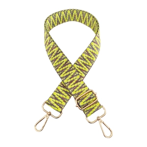 Detail of adjustable 3.8cm wide woven guitar strap with neon geometric patterns and gold hooks