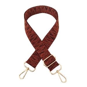 Detailed view of woven bag strap with adjustable gold buckle and lobster hooks