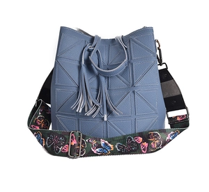 Blue textured leather bucket bag featuring geometric stitching and butterfly strap