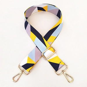 Close-up of colorful geometric ethnic pattern bag strap with gold metal swivel lobster clasps
