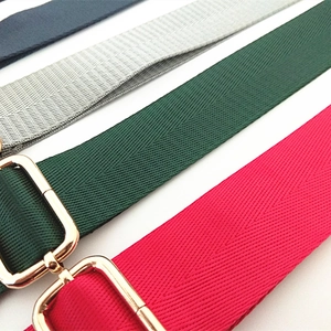 Close-up of herringbone nylon straps with golden adjustable buckles in four colors