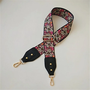Detail of vintage floral wide bag strap with gold metal hooks and adjustable buckle