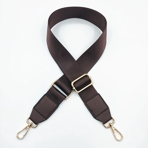 Adjustable nylon shoulder strap detail with brown leather ends and gold metal hooks