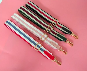 Detail view of four adjustable woven shoulder straps with gold metal hooks and leather accents