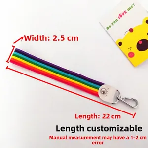 Detail view of a rainbow striped wrist strap with a silver metal lobster clasp, 2.5cm wide