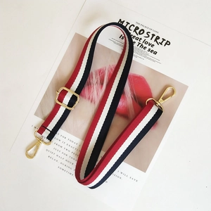 Detail of adjustable red white and navy striped canvas strap with gold lobster clasps