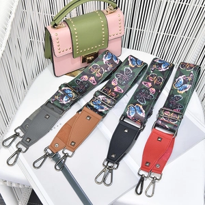 Wide colorful butterfly print shoulder straps with leather ends and metal buckles
