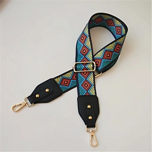 Detail of adjustable geometric colorful strap with gold hooks and leather ends