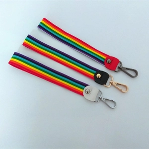 Colorful striped wristlet strap with metal clasp and leather accents in three colors