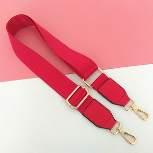 Adjustable red nylon shoulder strap with gold metal hooks and leather reinforcement