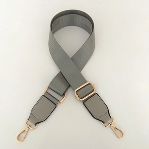 Grey adjustable nylon shoulder strap with gold metal lobster clasps and leather ends