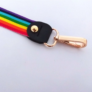 Rainbow striped woven hand strap with black leather trim and golden lobster clasp