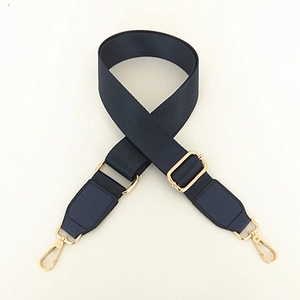 Macro shot of nylon shoulder strap with gold-tone metal buckle and lobster clasp