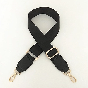 Detail of adjustable black nylon shoulder strap with golden metal hooks and buckles