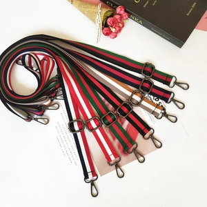Detail of adjustable colorful striped shoulder straps with vintage lobster clasps