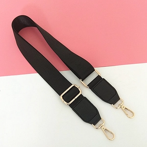 Adjustable black nylon bag strap with gold metal buckles and reinforced leather patches