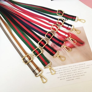 Adjustable striped shoulder straps with gold metal hardware for crossbody bags