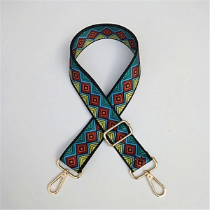 Close-up of ethnic geometric pattern strap with adjustable golden metal hook and buckle