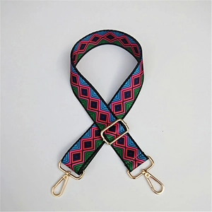 Close-up of bohemian geometric patterned adjustable strap with gold metal hooks
