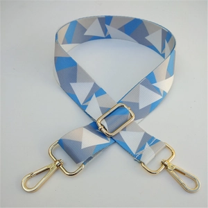 Adjustable wide replacement bag strap with blue and grey geometric patterns and gold clips