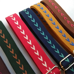 Adjustable woven canvas shoulder strap with chevron embroidery and gold metal hardware