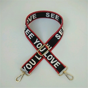 Detail of adjustable ethnic style wide bag strap with red and black lettering design