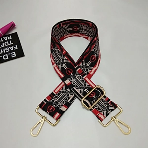 Detail of red heart jacquard strap with gold-tone hardware for crossbody bags