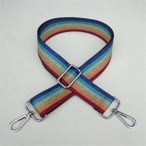 Close-up of rainbow striped thick bag strap with silver metal lobster clasps and buckle