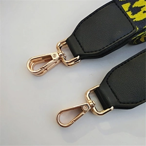 Adjustable leopard print bag strap with golden metal hooks and black leather ends