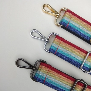 Macro view of wide rainbow sequin bag strap with gold, silver, and gunmetal clips