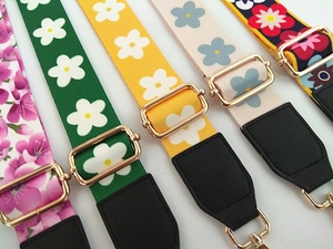 Detail showing five floral replacement straps with adjustable gold metal hardware