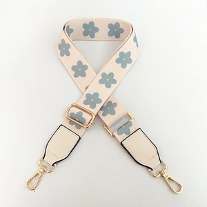 Adjustable off-white shoulder strap with grey-blue flower patterns and gold lobster clasps