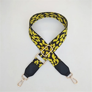 Adjustable leopard print bag strap with black leather ends and gold metal buckles