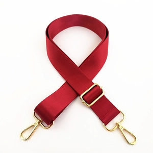 Detail of adjustable burgundy nylon strap with high-quality golden metal swivel hooks