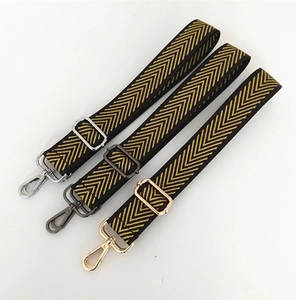 Adjustable nylon shoulder strap with yellow chevron pattern and various metal hardware clips