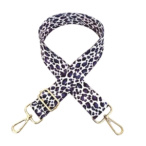 Adjustable leopard print bag strap with white and purple patterns and gold metal clips