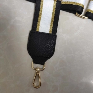 Adjustable black, white and gold striped webbing strap with gold swivel hooks for bags
