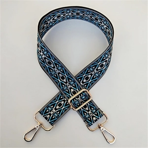 Ethnic style embroidered handbag strap with blue geometric patterns and gold metal clips