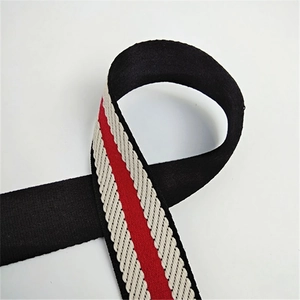 Macro shot of thick adjustable woven shoulder strap with black, red and white stripes