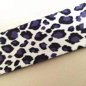 Macro detail of high-density purple leopard print woven wide strap texture